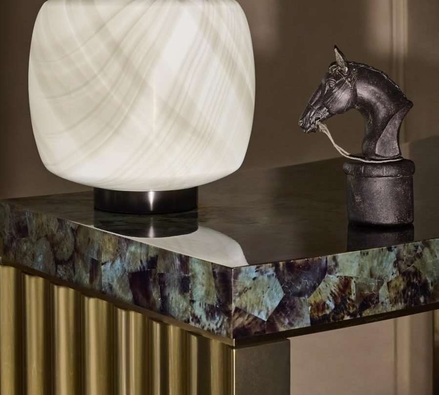 Stone-top console with brass and glass lamp